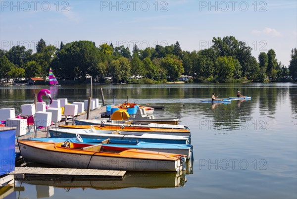 Electric boats on the shore of the Waginger See