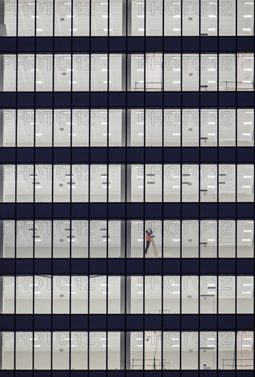 Worker in the facade of an office building on the outskirts of Madrid