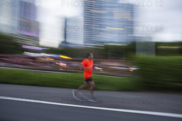 Jogger on the sidewalk next to Balboa Avenue