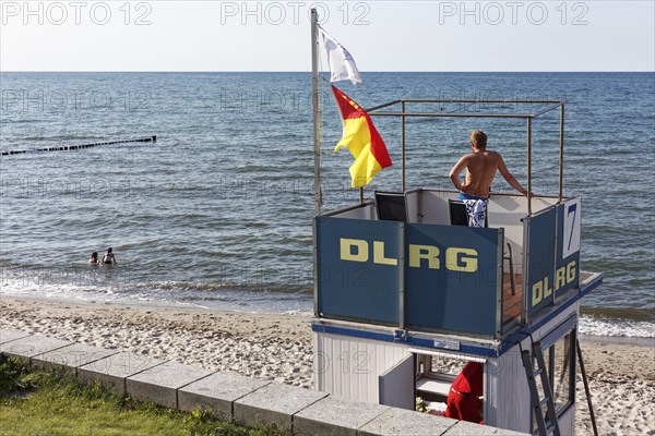 Beach guard observes two bathers