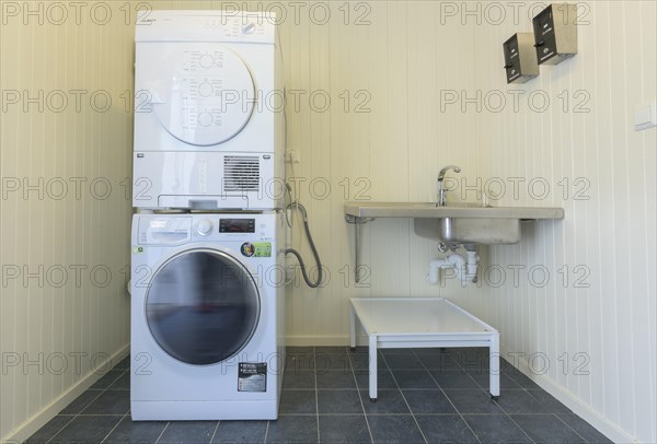 Washroom with large washing machine and dryer