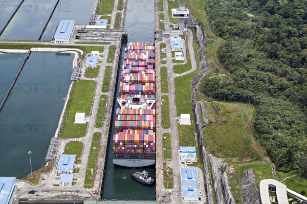 Aerial view of Neo-Panamax container ship crossing the third set of locks at the pacific side