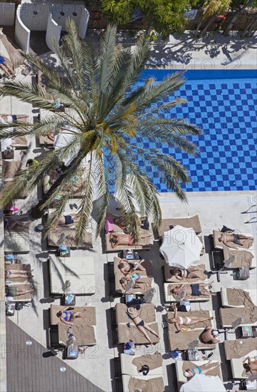 Tourists at the swimming pool in a hotel in Marbella