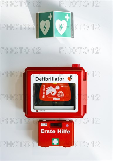 Defibrillator and first aid kit hanging on a wall in public space at Duesseldorf Airport