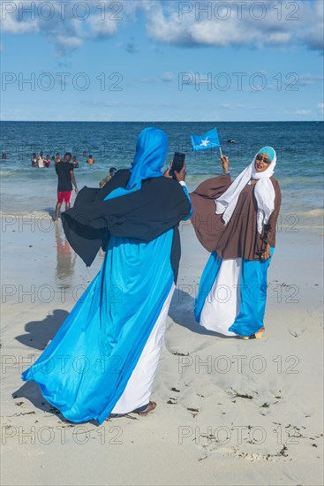Local women posing for photos on Lido beach