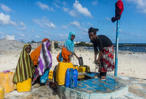 Local girls collecting water at a water well