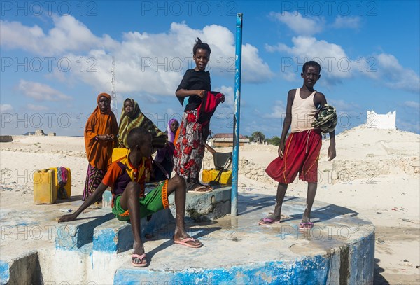Local girls collecting water at a water well