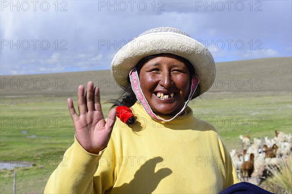 Indigenous woman waves into the camera