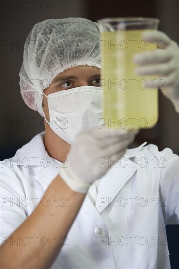 Employee measures rosemary oil at the cosmetics factory in Itupeva