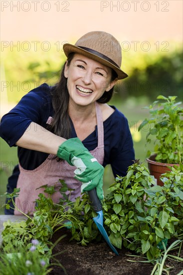 Woman doing gardening on a raised bed