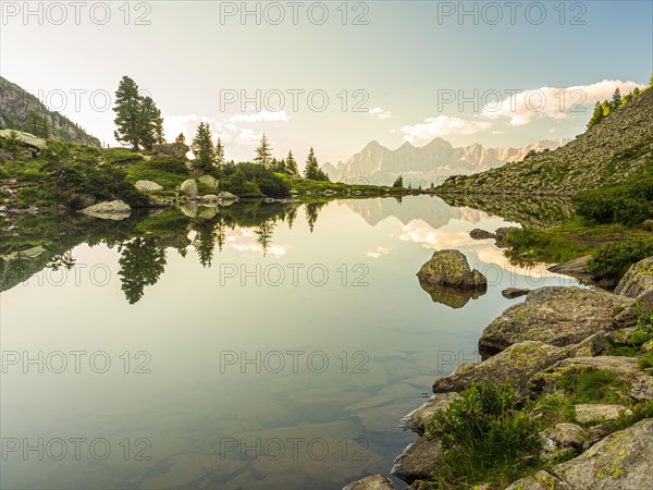 The Hoher Dachstein is reflected in the lake of mirrors at last daylight