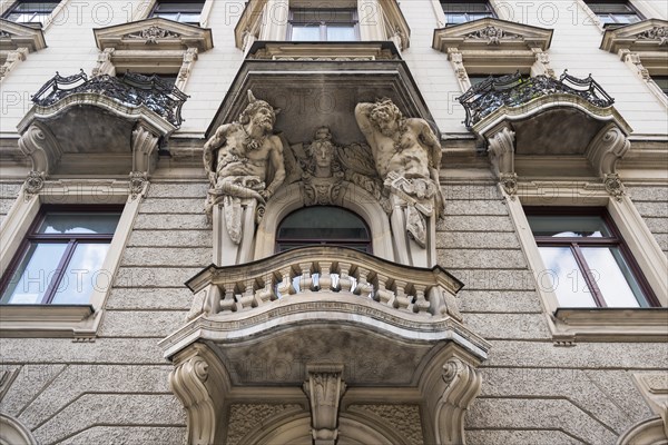 Baroque facade with balconies and atlases