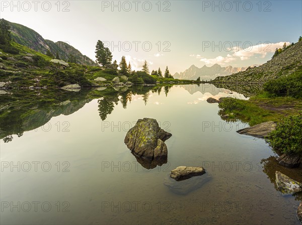 The Hoher Dachstein is reflected in the lake of mirrors at last daylight