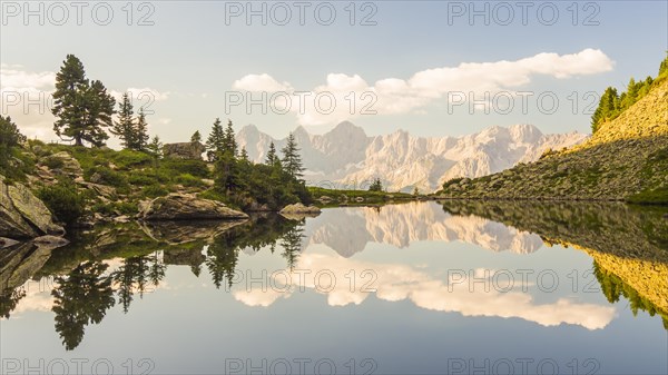 The Hoher Dachstein is reflected in the lake of mirrors at last daylight