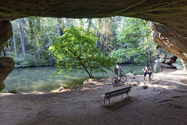 Bank and cyclist in front of Gutav Adolf cave