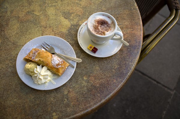 Cappuccino and apple strudel with vanilla ice cream and cream