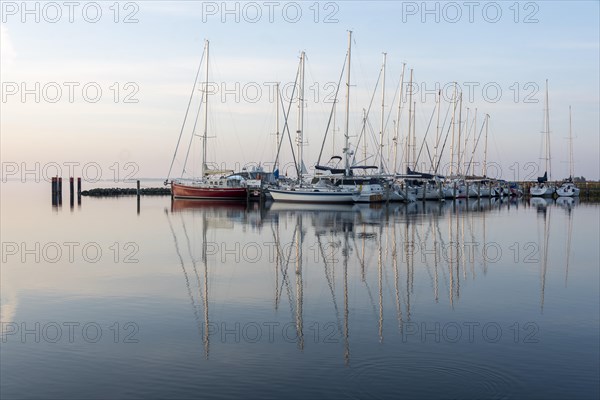 Sailing boats reflected in the water of the Bodden