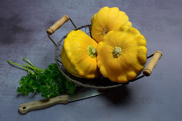 Yellow patisson pumpkins in wire basket