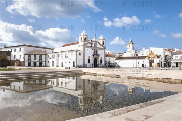 Church of Santa Maria and fountain with water reflection