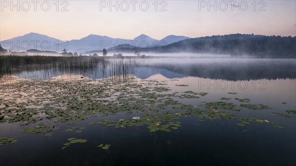 Sunrise with wafts of mist over the Lake Turnersee