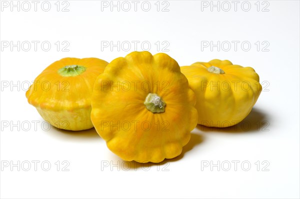 Three yellow patisson pumpkins