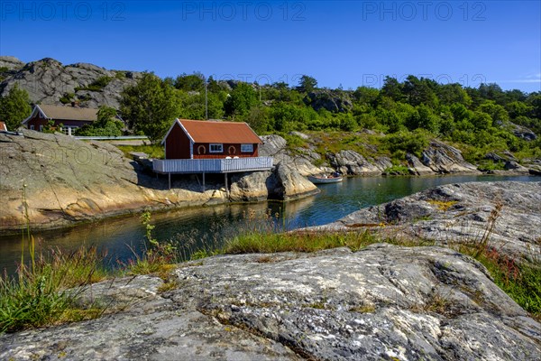 Red cottage by the water