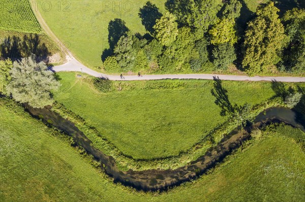 Meandering river Grosse Lauter with cyclists