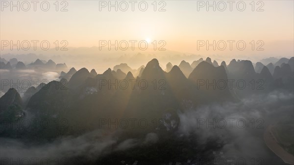 Chinese karst mountains at the Yangshuo River at sunrise