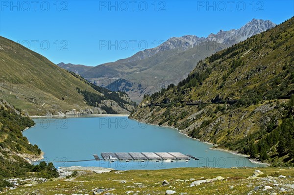 Mountain lake Lac des Toules with solar panels of the first floating alpine solar power plant in Switzerland