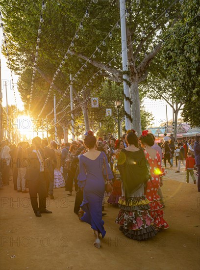 Celebrating Spaniards in traditional dress in front of marquees