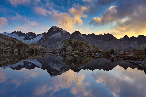 Graetlisee with reflection of the mountains and clouds in the morning light