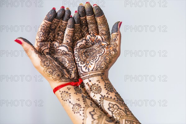 Hand of a bride painted with henna on the eve of the wedding