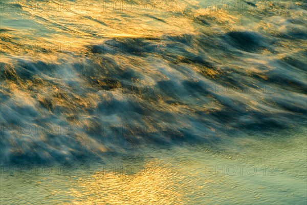 Running waves on the beach at sunset