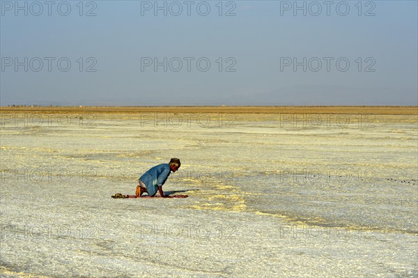 Believer Muslim praying in the desert