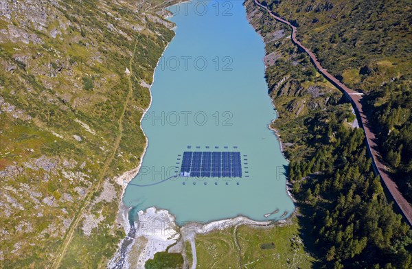 Solar collectors of a solar power plant floating on the mountain lake Lac des Toules