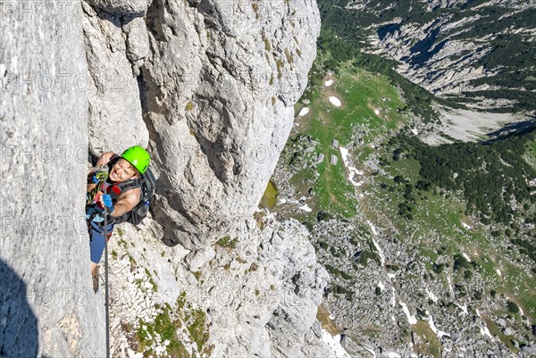 Young man climbing a rock face