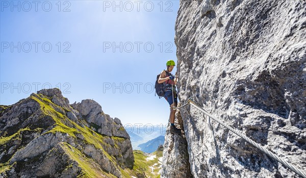 Young man climbing a rock face