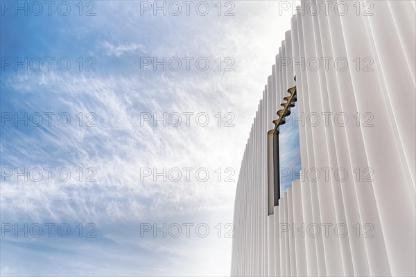 Modern white facade of corrugated acrylic glass with window