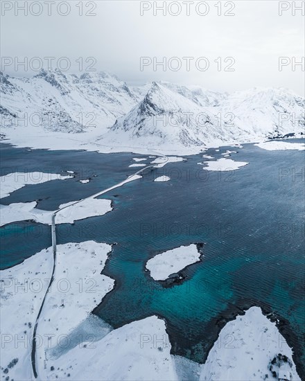 Snowy landscape by the fjord with Fredvang bridges