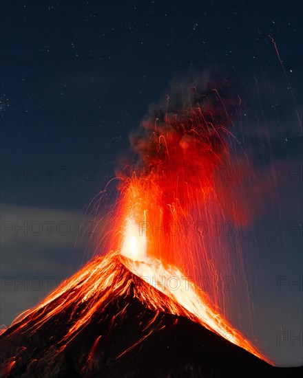 Glowing lava and smoke spitting volcano