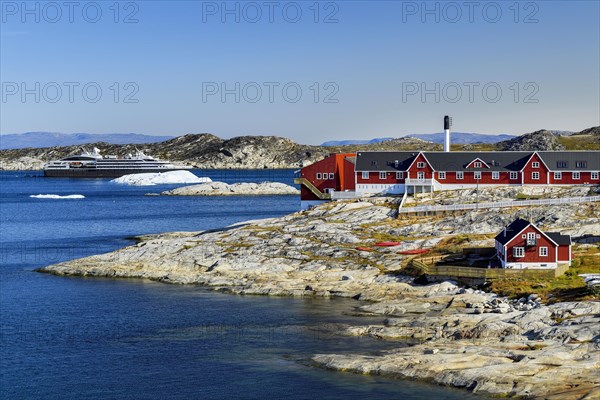 Colourful houses with view into Disko Bay to the cruise ship Ponant