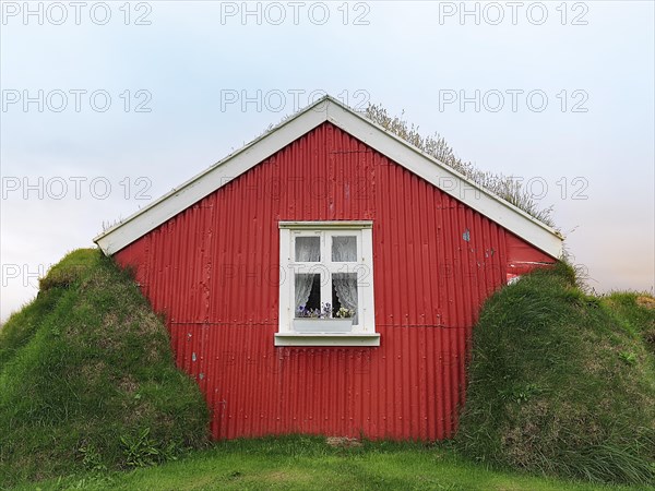 Traditional peat house Lindarbakki with red gable wall