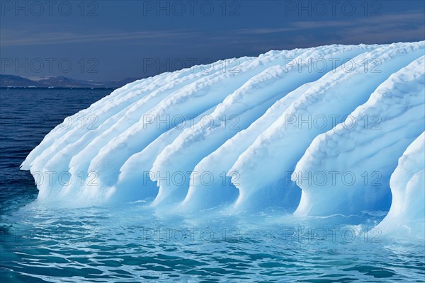 Rugged iceberg drifting through Icefjord