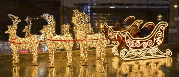 Electric sculptures of golden deers and carriage with Santa Claus