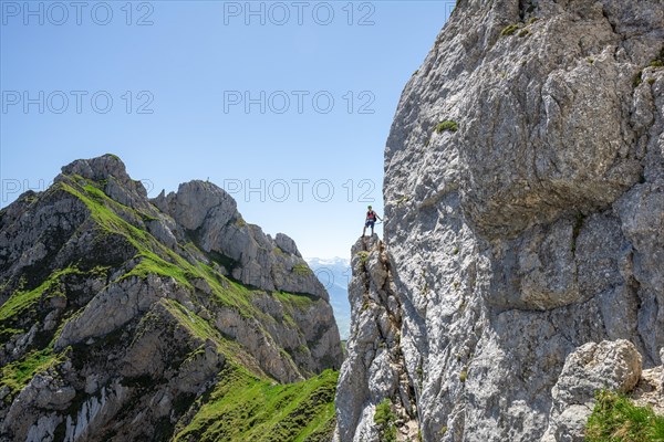 Young man climbing a rock face