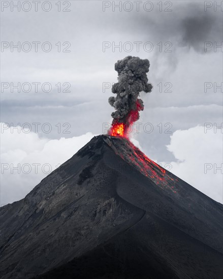 Glowing lava and smoke spitting volcano