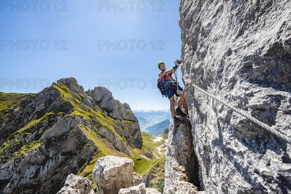 Young man climbing a rock face