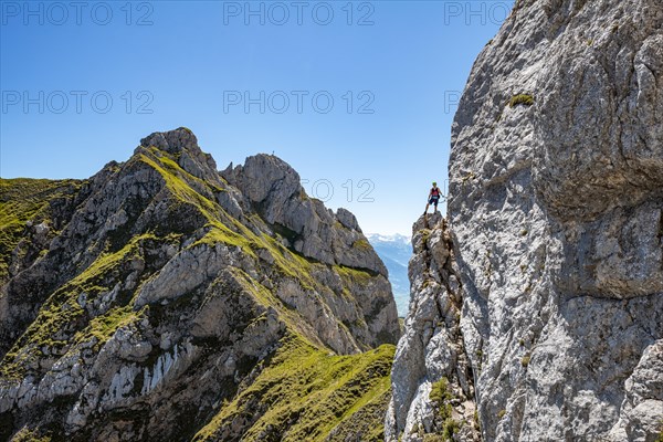 Young man climbing a rock face