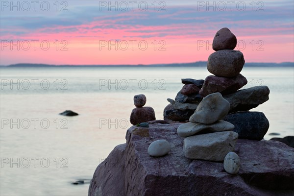 Stone pyramids on the beach at sunset