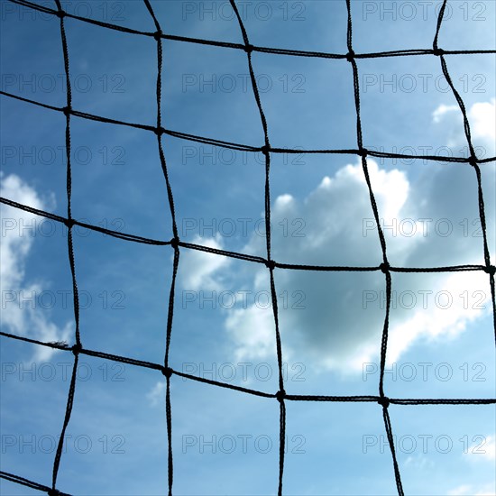 Football goal net against cloudy sky